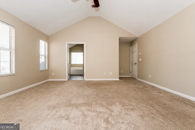 an empty room with windows and closet