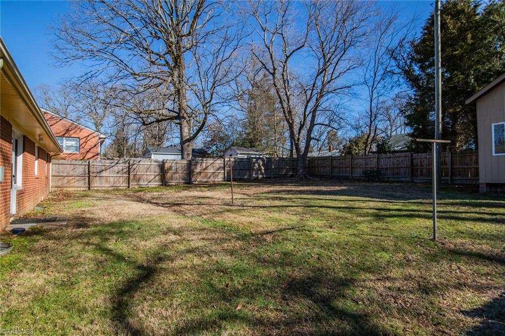 604 Ashe Street High Point, NC 27262 - Photo 22 of 23 Large fenced in backyard with storage unit