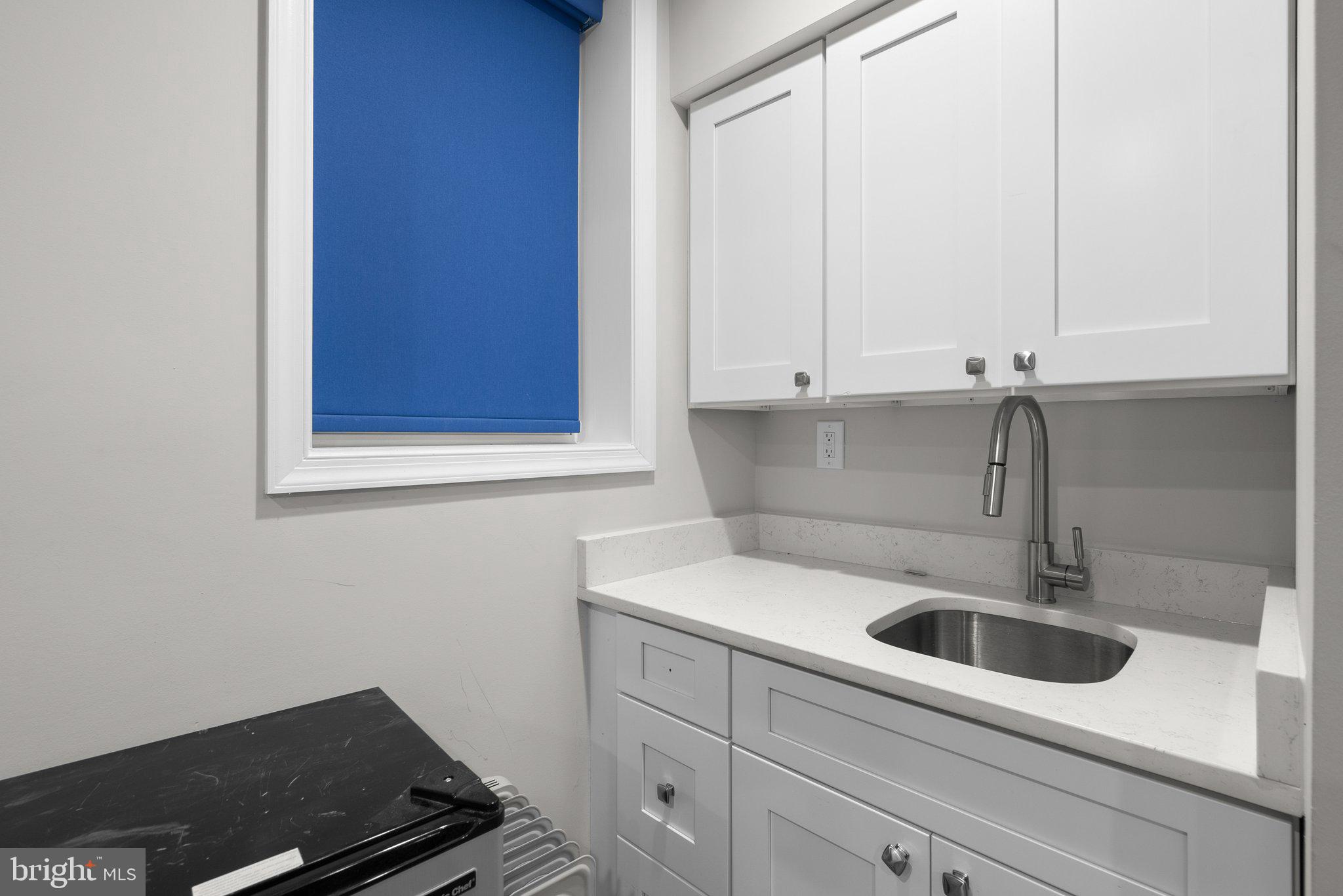 1275 Oates Street Northeast Washington, DC 20002 - Photo 31 of 40 a kitchen with a sink and cabinets