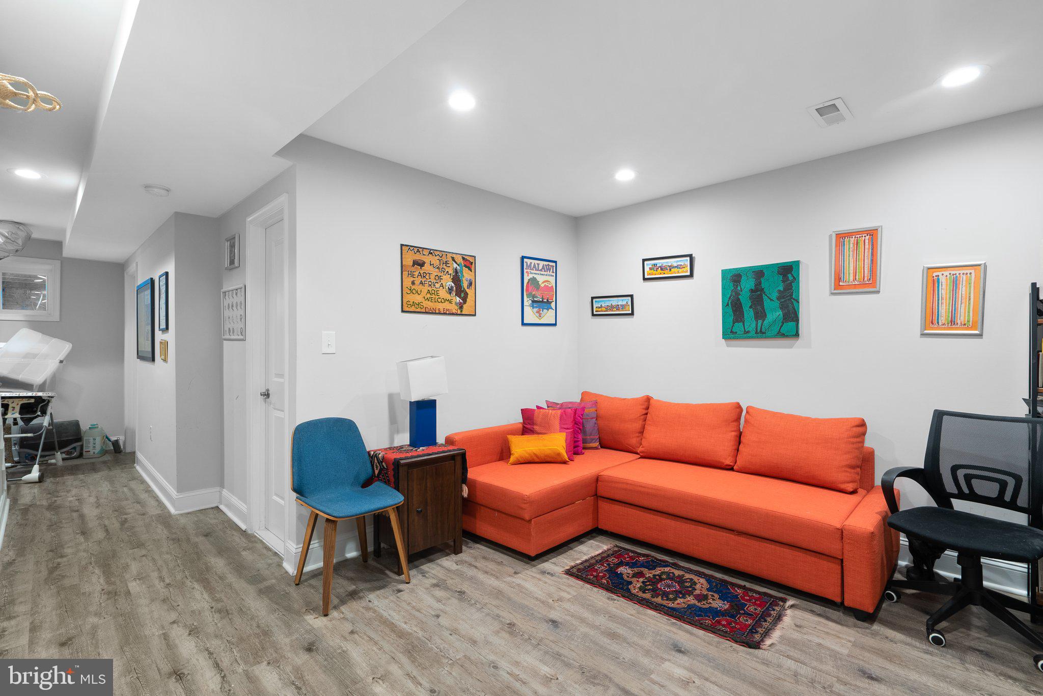 1275 Oates Street Northeast Washington, DC 20002 - Photo 32 of 40 a blue room with furniture and a wooden floor