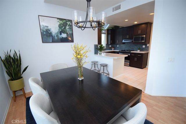a living room with dining table furniture a window and a flat screen tv