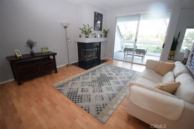 a view of a big room with wooden floor and cabinet