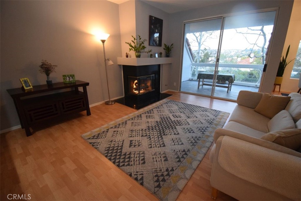17 La Paloma Dana Point, CA 92629 - Photo 25 of 36 a living room with furniture a large window and a fireplace