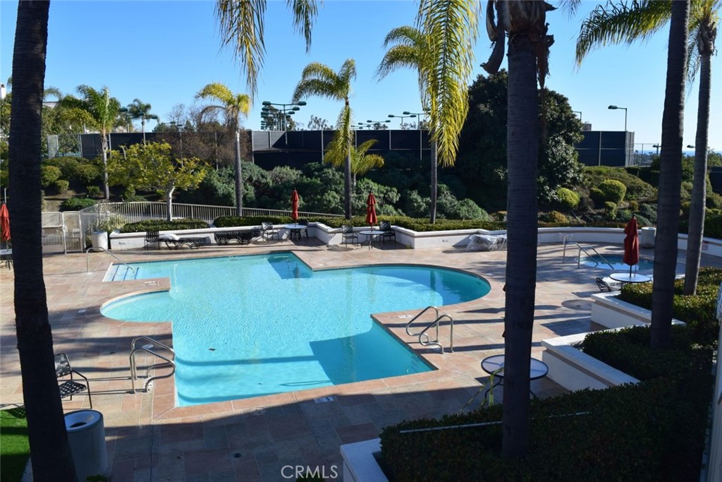 17 La Paloma Dana Point, CA 92629 - Photo 32 of 36 a view of a swimming pool with a table and chairs