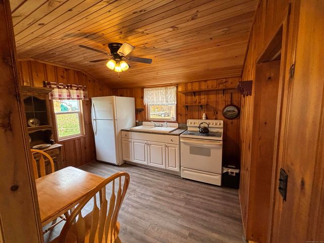 a kitchen with cabinets wooden floor and a stainless steel appliances
