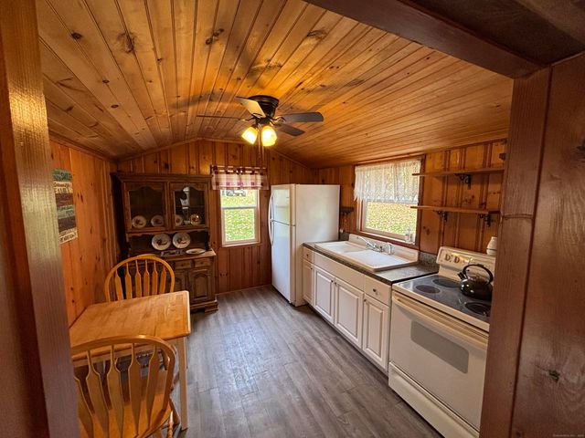 a kitchen with granite countertop a stove and a refrigerator