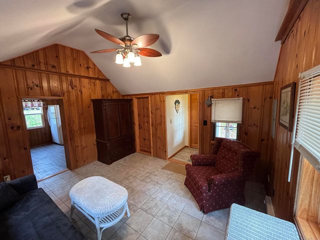 a living room with furniture a chandelier and a flat screen tv