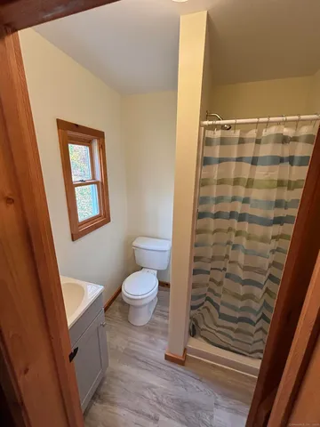 a bathroom with a toilet and a shower