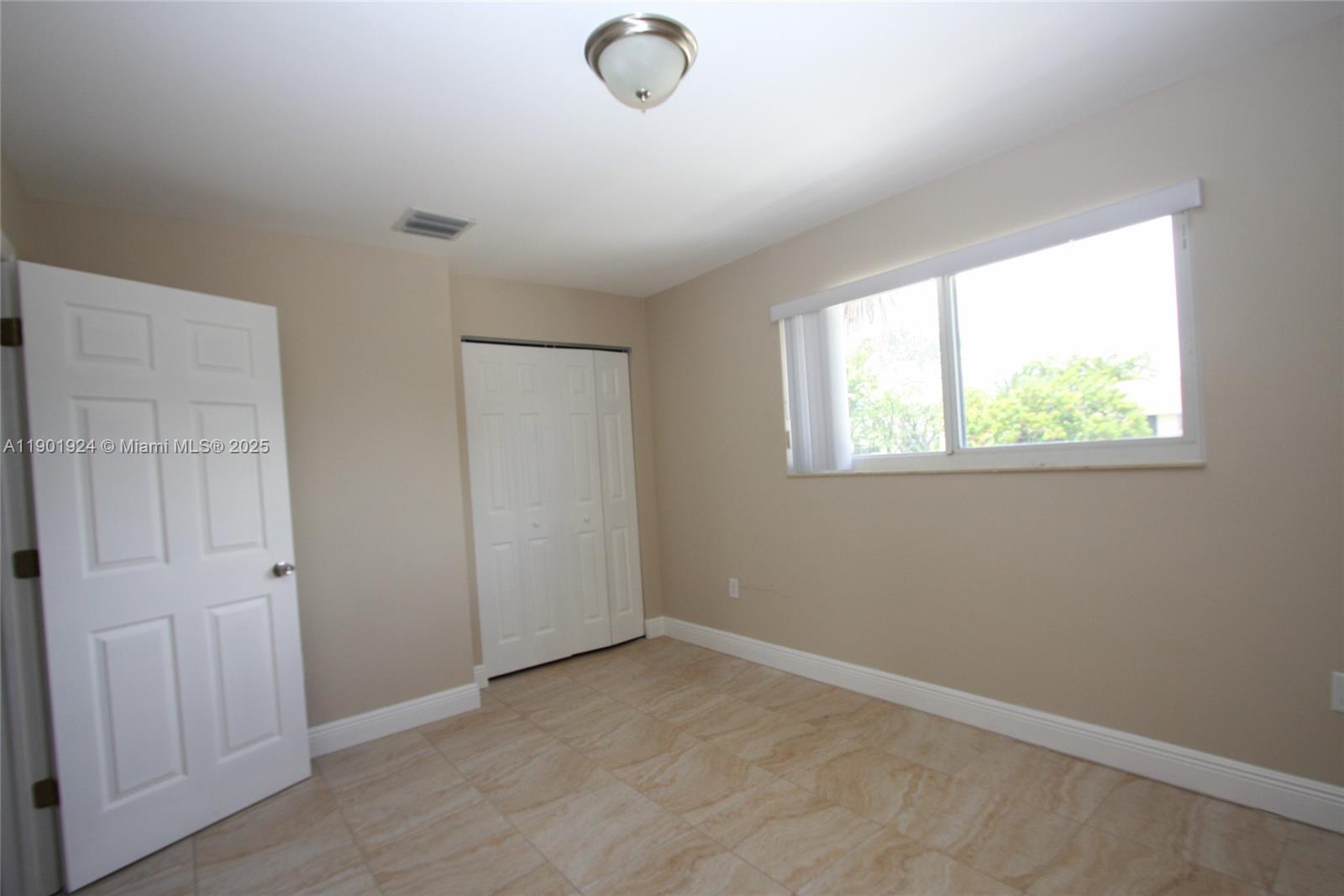 479 Northwest 19th Street, Unit 352 Miami, FL 33136 - Photo 12 of 16 an empty room with windows