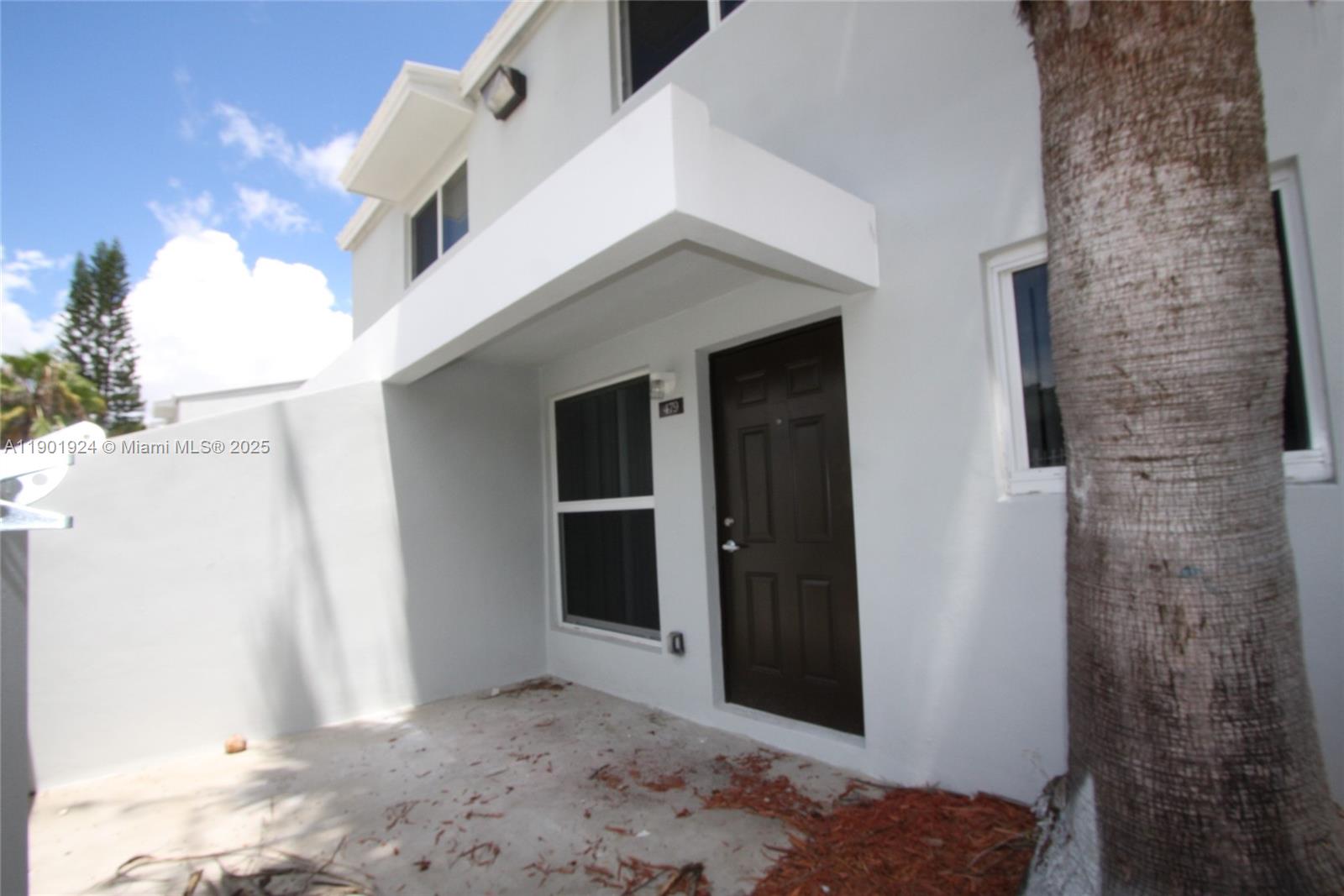 479 Northwest 19th Street, Unit 352 Miami, FL 33136 - Photo 15 of 16 a view of a white house with a yard