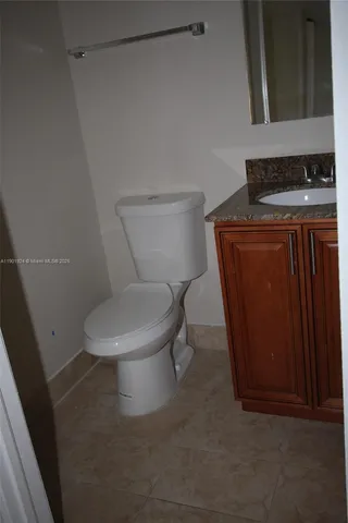 a white toilet sitting next to a sink