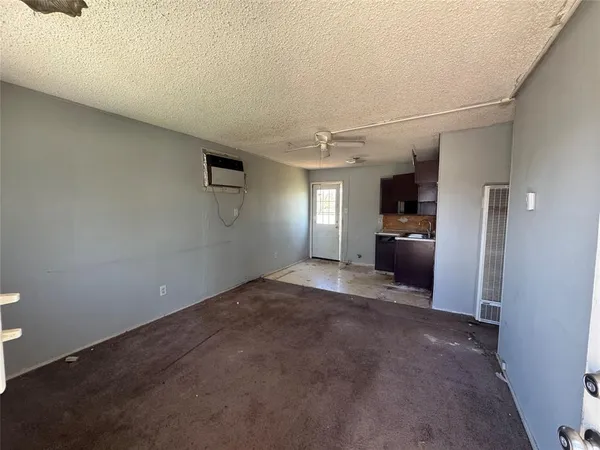a view of a utility room with windows and cabinet
