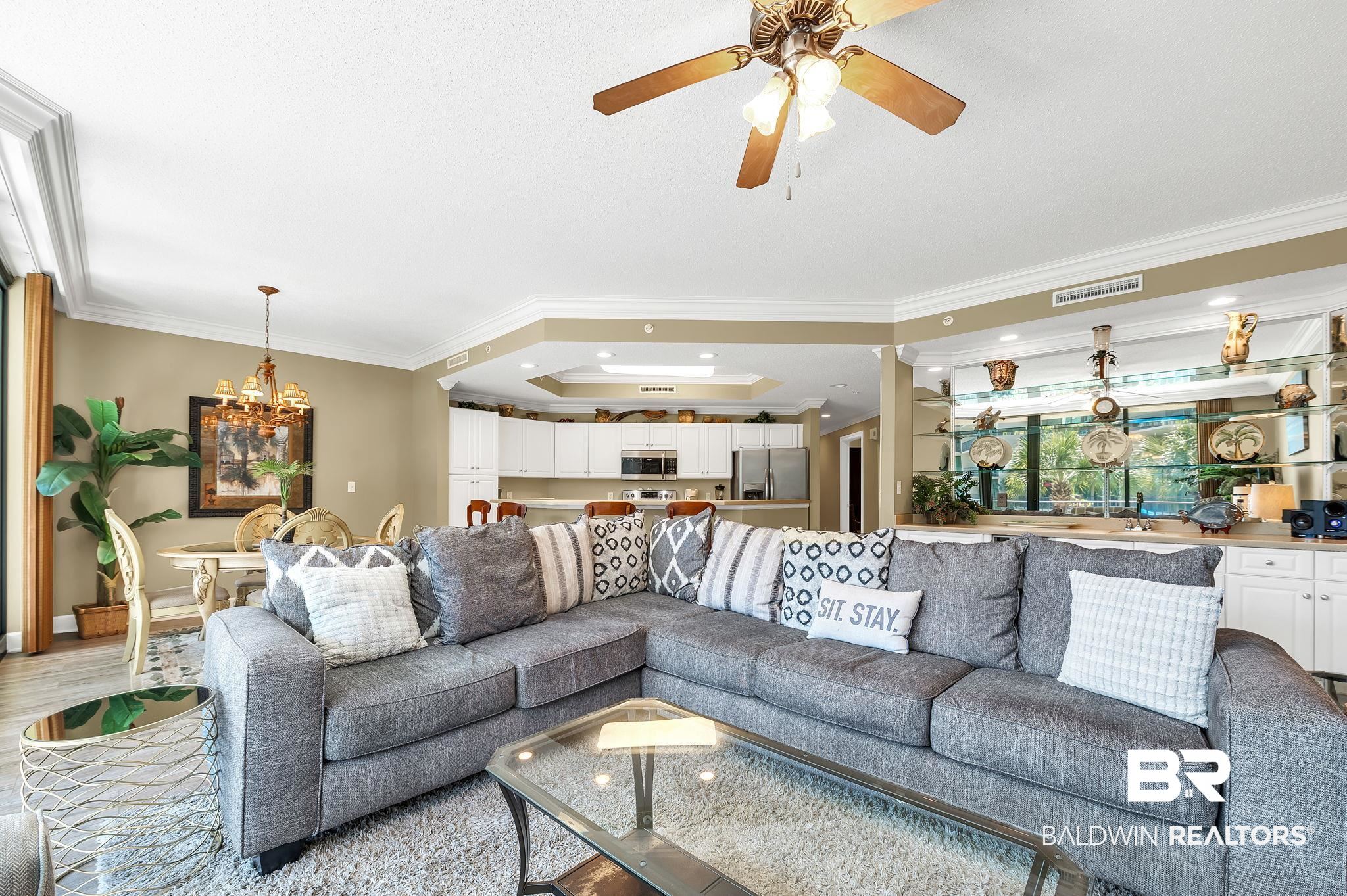 27580 Canal Road, Unit 1214 AND BOAT SLIP #62 Orange Beach, AL 36561 - Photo 13 of 67 Living room featuring light wood-style floors, visible vents, ceiling fan with notable chandelier, and ornamental molding
