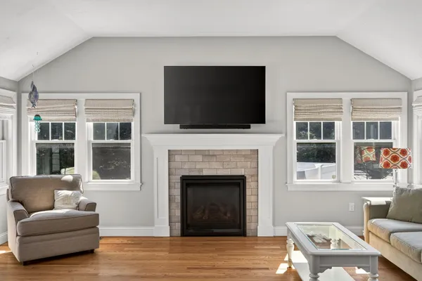 a living room with furniture a flat screen tv and a fireplace