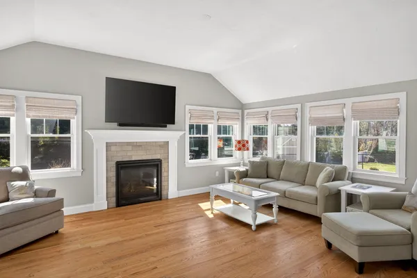 a living room with furniture a flat screen tv and a fireplace