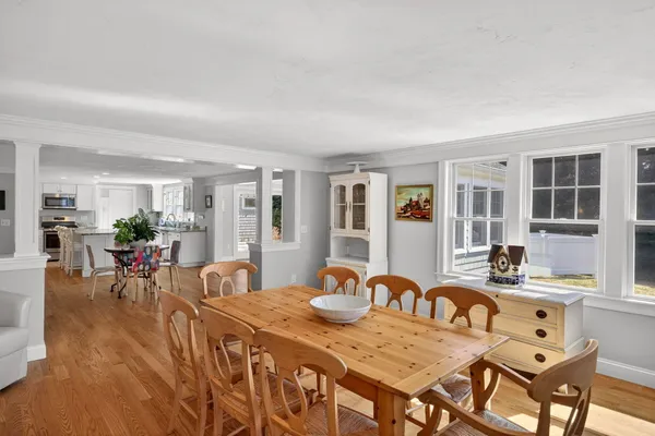 a view of a dining room with furniture window and wooden floor