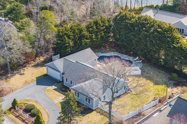 an aerial view of a house with a yard basket ball court and outdoor seating