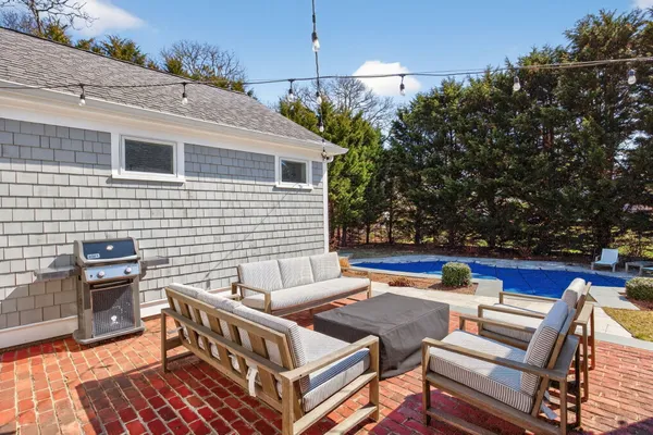 a view of a patio with couches table and chairs and potted plants