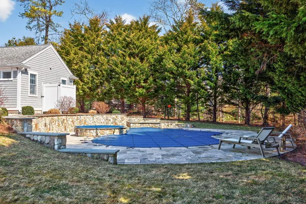 a view of a swimming pool with an outdoor space and seating area