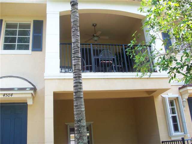 a front view of a house with a tree