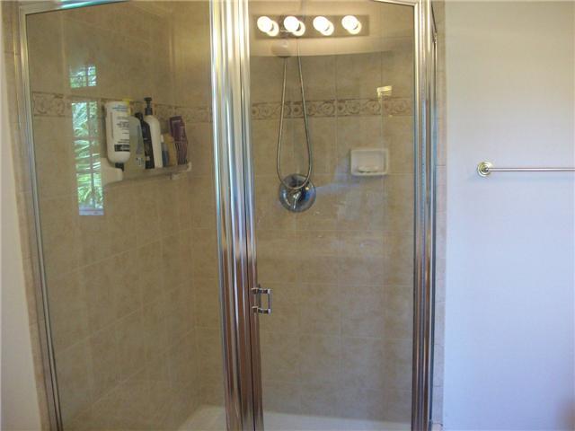 4508 Danson Way Delray Beach, FL 33445 - Photo 18 of 25 a bathroom with a glass shower door