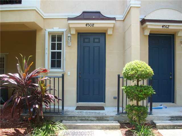 4508 Danson Way Delray Beach, FL 33445 - Photo 20 of 25 a vase of flowers sitting on a table in front of a door