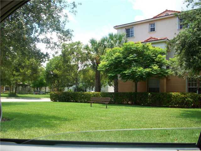4508 Danson Way Delray Beach, FL 33445 - Photo 23 of 25 a front view of a house with a yard
