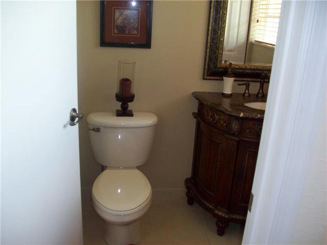4508 Danson Way Delray Beach, FL 33445 - Photo 7 of 25 a bathroom with a toilet a sink and mirror