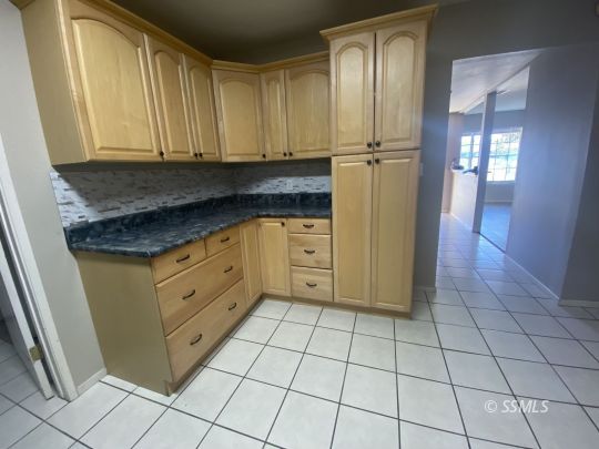 519 South Fairview Street Ridgecrest, CA 93555 - Photo 8 of 20 a kitchen with granite countertop white cabinets and stainless steel appliances