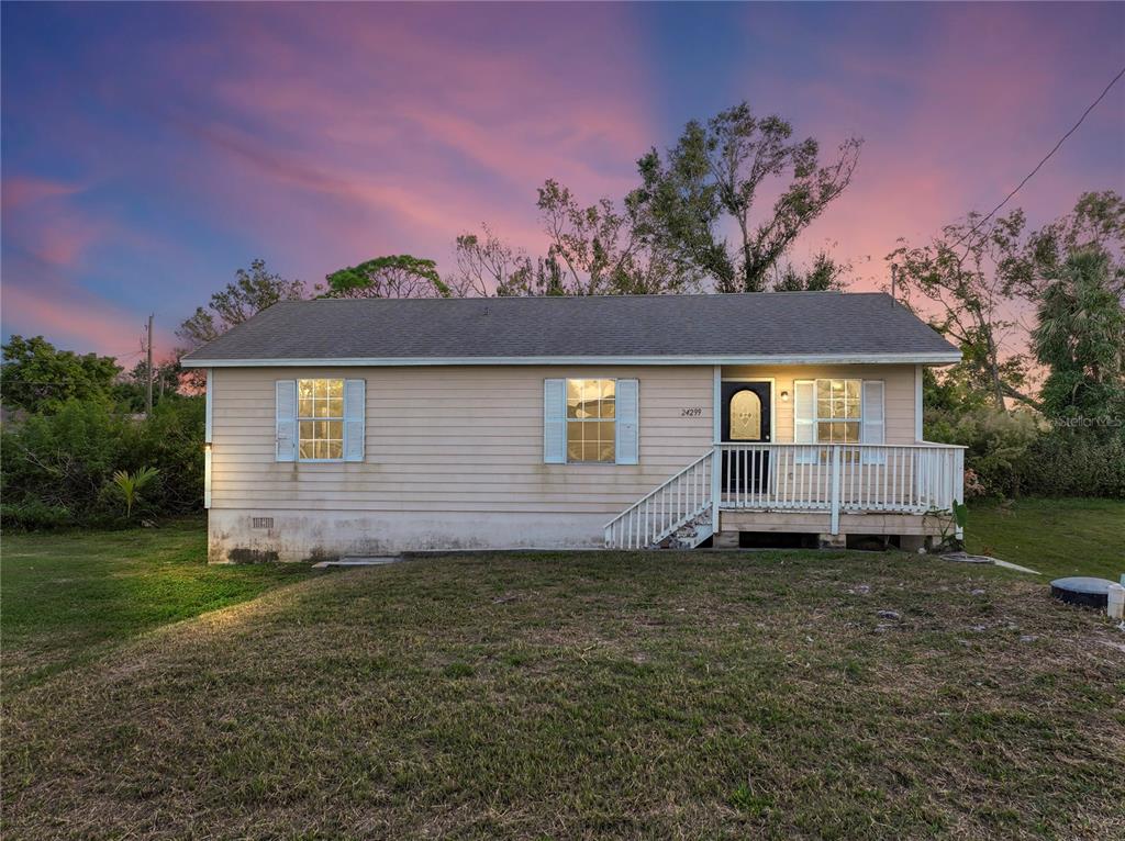 24299 Airport Road Punta Gorda, FL 33950 - Photo 1 of 1 a view of a house with a yard