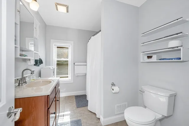 a bathroom with a sink a toilet and tub