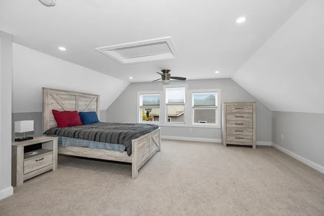 a spacious bedroom with a bed and a walk in closet