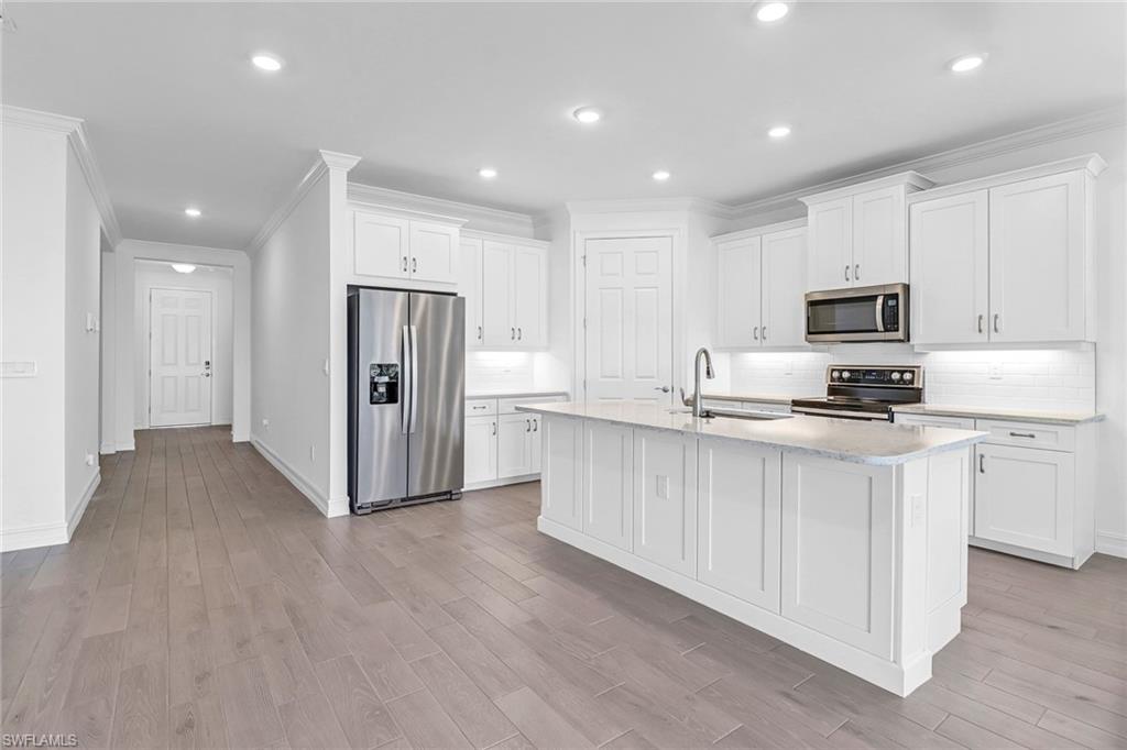317 Spiaggio Court Naples, FL 34114 - Photo 20 of 46 a kitchen with stainless steel appliances granite countertop a refrigerator oven a stove top oven a sink and dishwasher