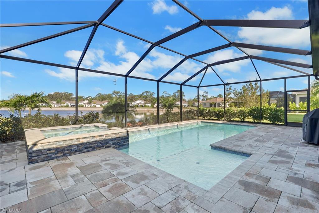 317 Spiaggio Court Naples, FL 34114 - Photo 2 of 46 a view of a swimming pool with a porch