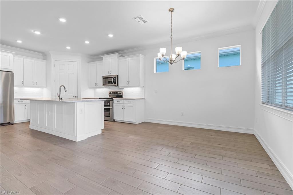 317 Spiaggio Court Naples, FL 34114 - Photo 21 of 46 a view of kitchen with granite countertop cabinets and stainless steel appliances