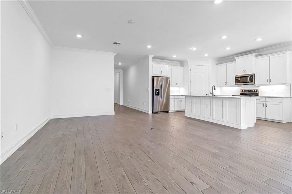 317 Spiaggio Court Naples, FL 34114 - Photo 23 of 46 a view of kitchen with wooden floor and electronic appliances