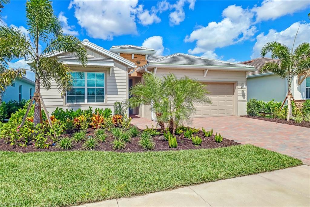 317 Spiaggio Court Naples, FL 34114 - Photo 26 of 46 a front view of a house with a garden