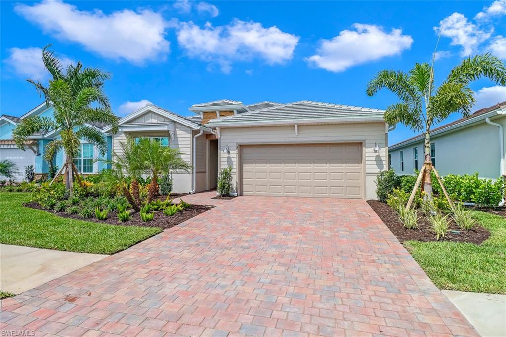 317 Spiaggio Court Naples, FL 34114 - Photo 3 of 46 a front view of a house with a yard and a garage