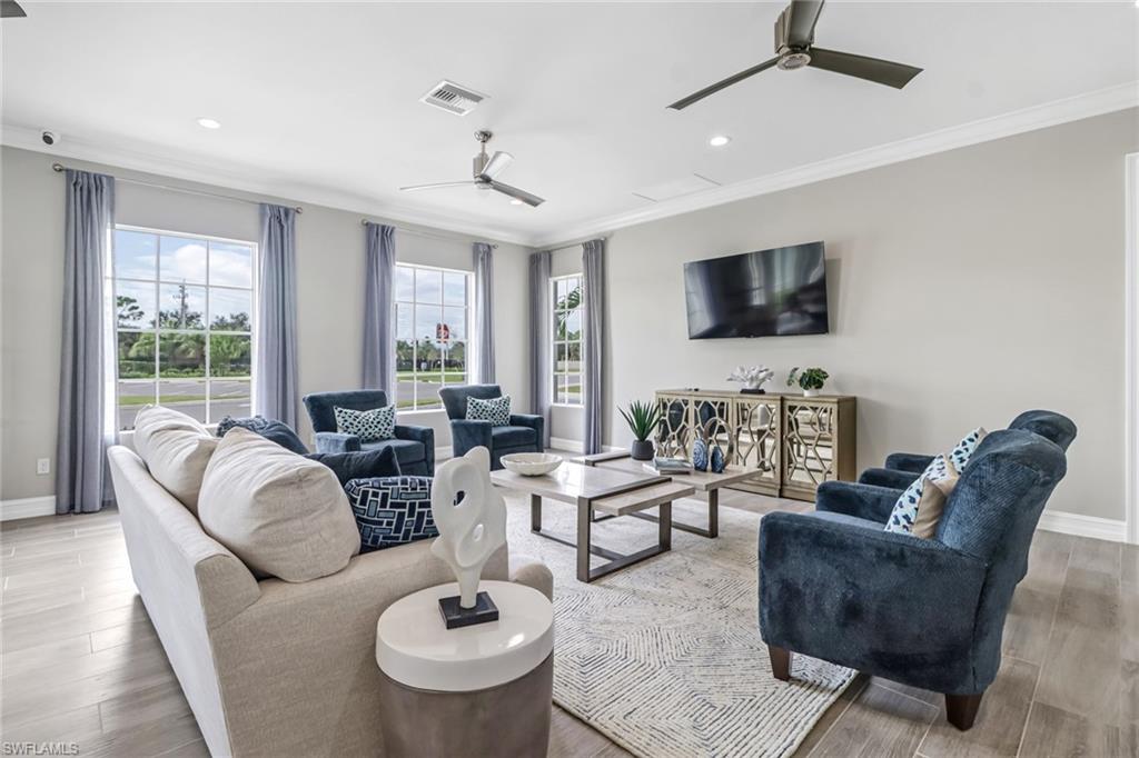 317 Spiaggio Court Naples, FL 34114 - Photo 37 of 46 a living room with furniture a flat screen tv and a large window