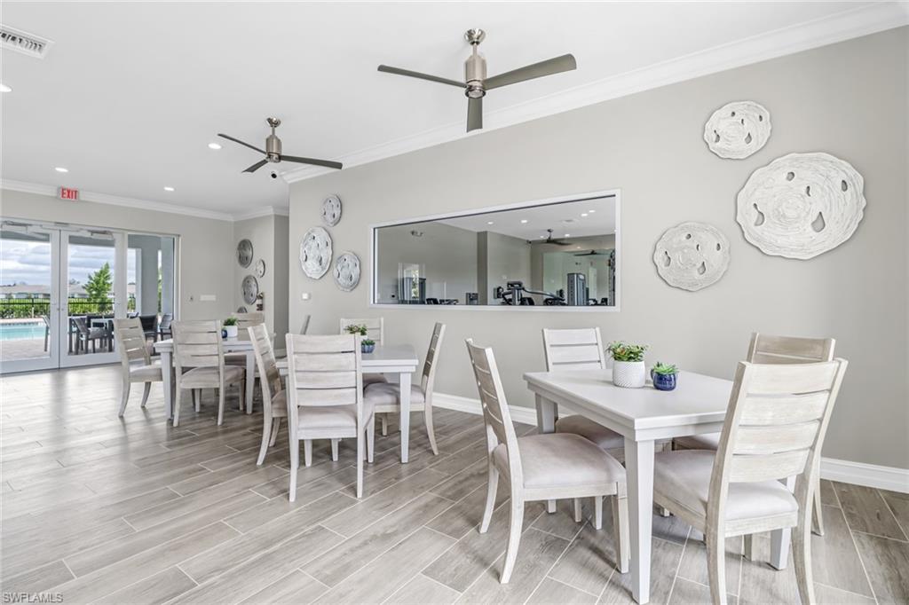 317 Spiaggio Court Naples, FL 34114 - Photo 39 of 46 a dining room with furniture a painting on the wall and wooden floor