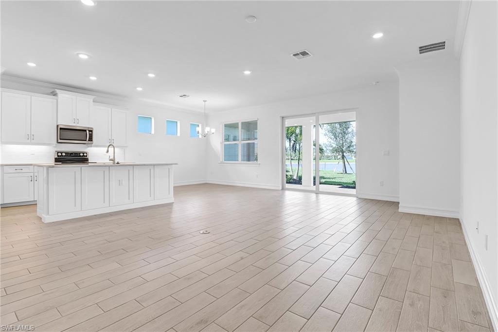 317 Spiaggio Court Naples, FL 34114 - Photo 5 of 46 a view of kitchen with furniture and wooden floor