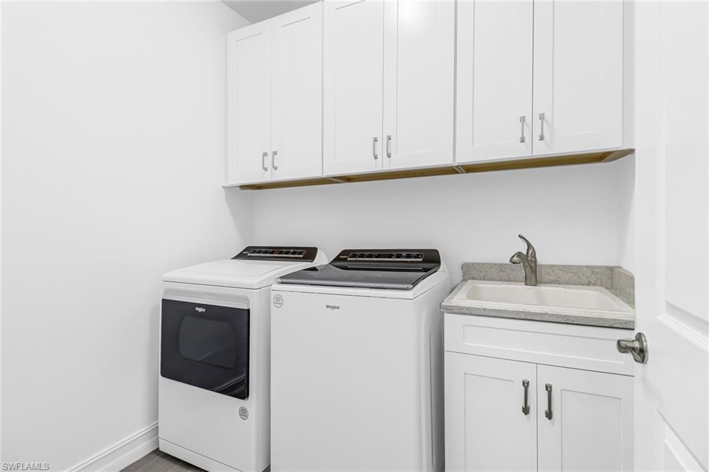 317 Spiaggio Court Naples, FL 34114 - Photo 9 of 46 a utility room with dryer and washer