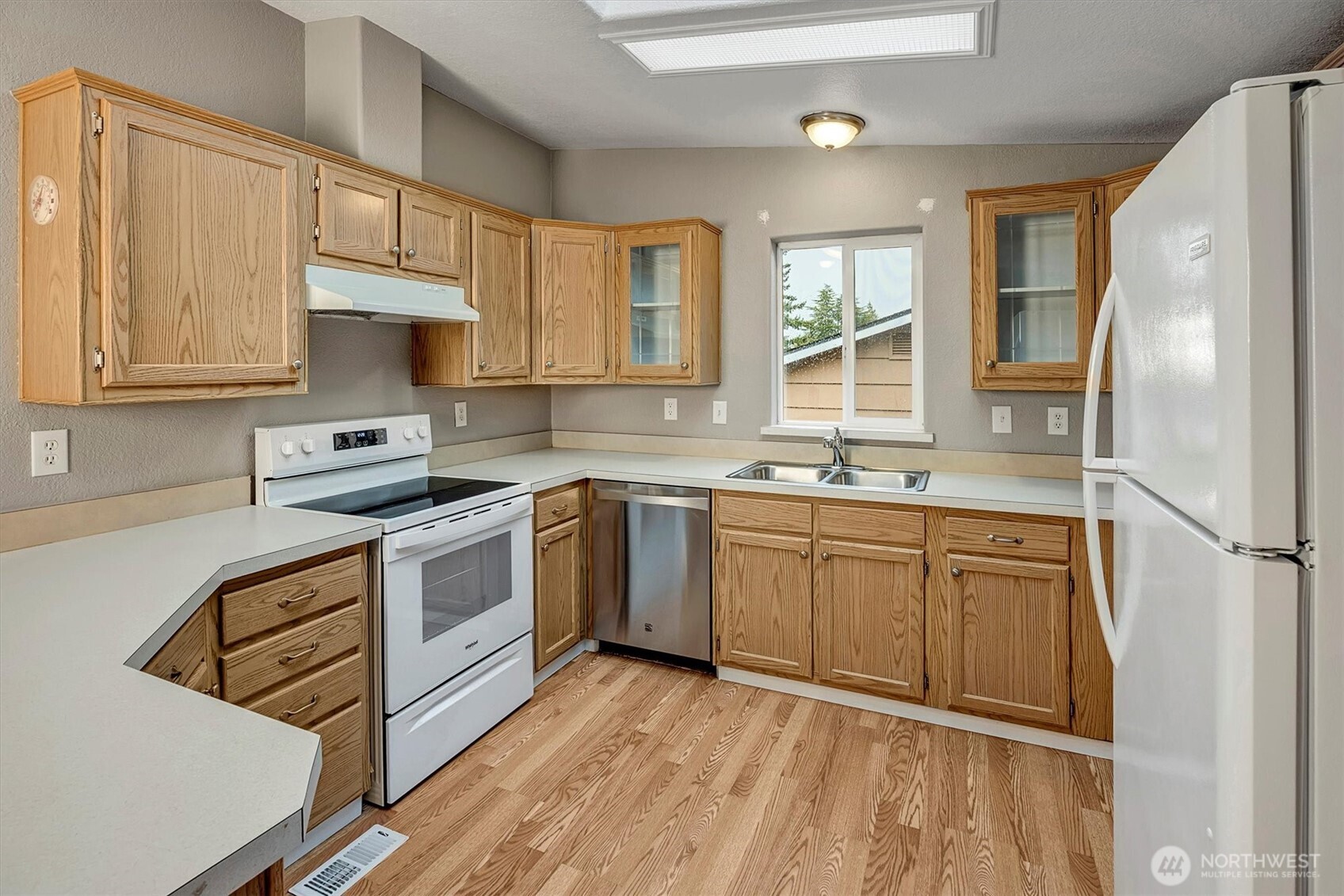 6407 Cady Road, Unit C Everett, WA 98203 - Photo 11 of 27 a kitchen with stainless steel appliances granite countertop a refrigerator sink and cabinets
