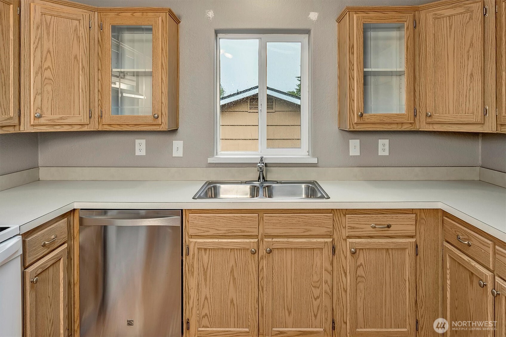 6407 Cady Road, Unit C Everett, WA 98203 - Photo 12 of 27 a kitchen with stainless steel appliances granite countertop white cabinets and a sink