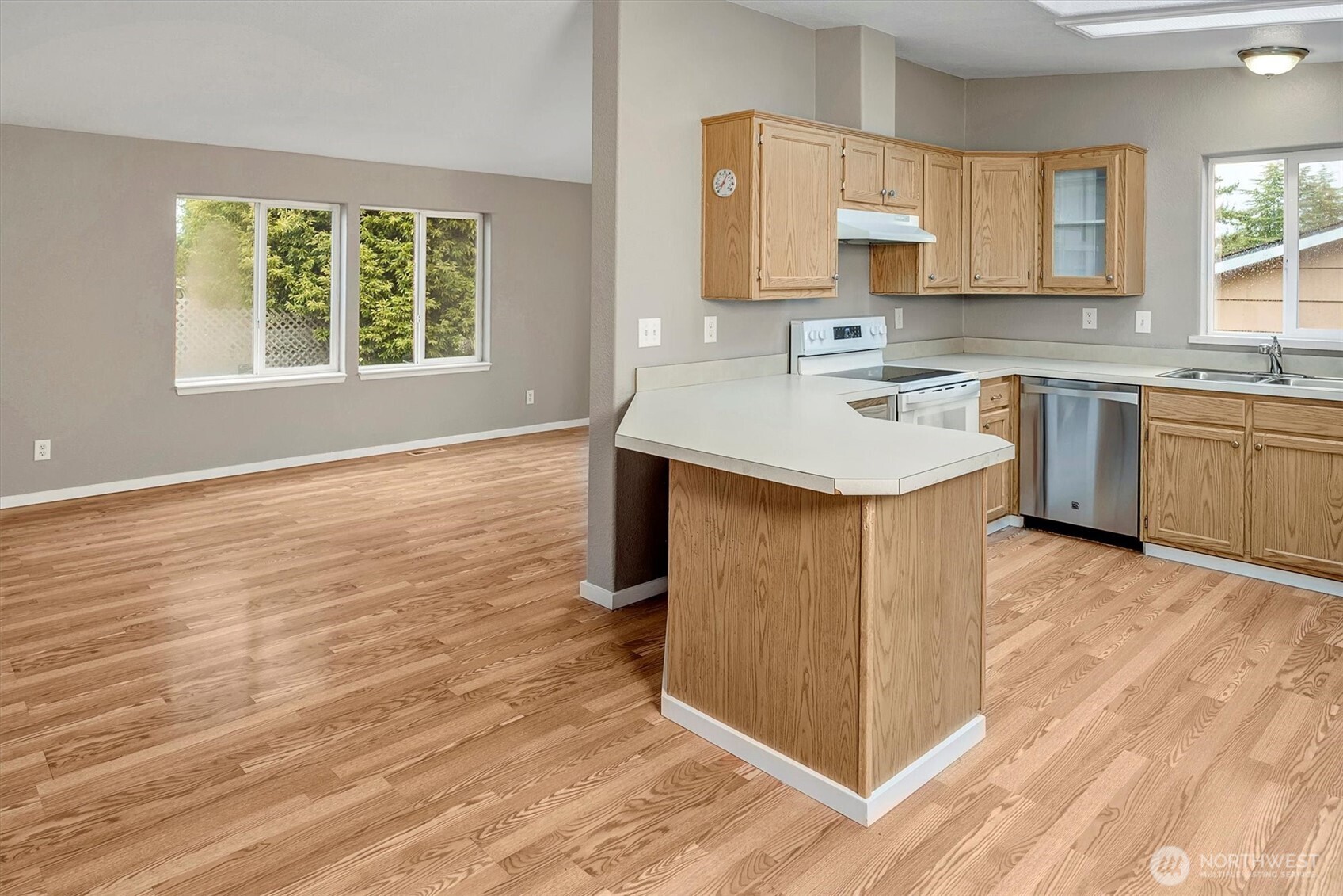 6407 Cady Road, Unit C Everett, WA 98203 - Photo 13 of 27 a kitchen with stainless steel appliances granite countertop a sink stove and wooden floor