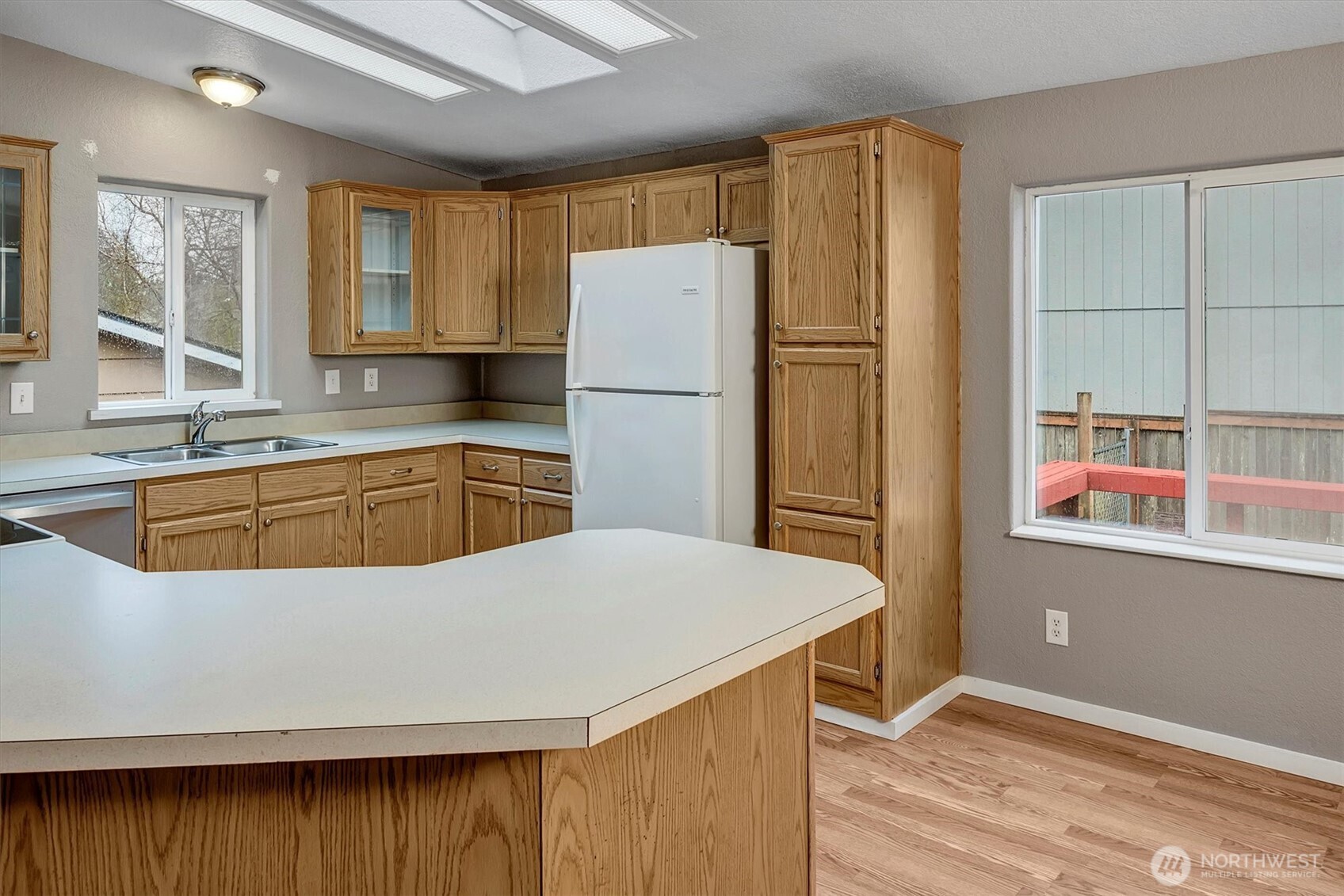 6407 Cady Road, Unit C Everett, WA 98203 - Photo 14 of 27 a kitchen with a refrigerator a sink and cabinets