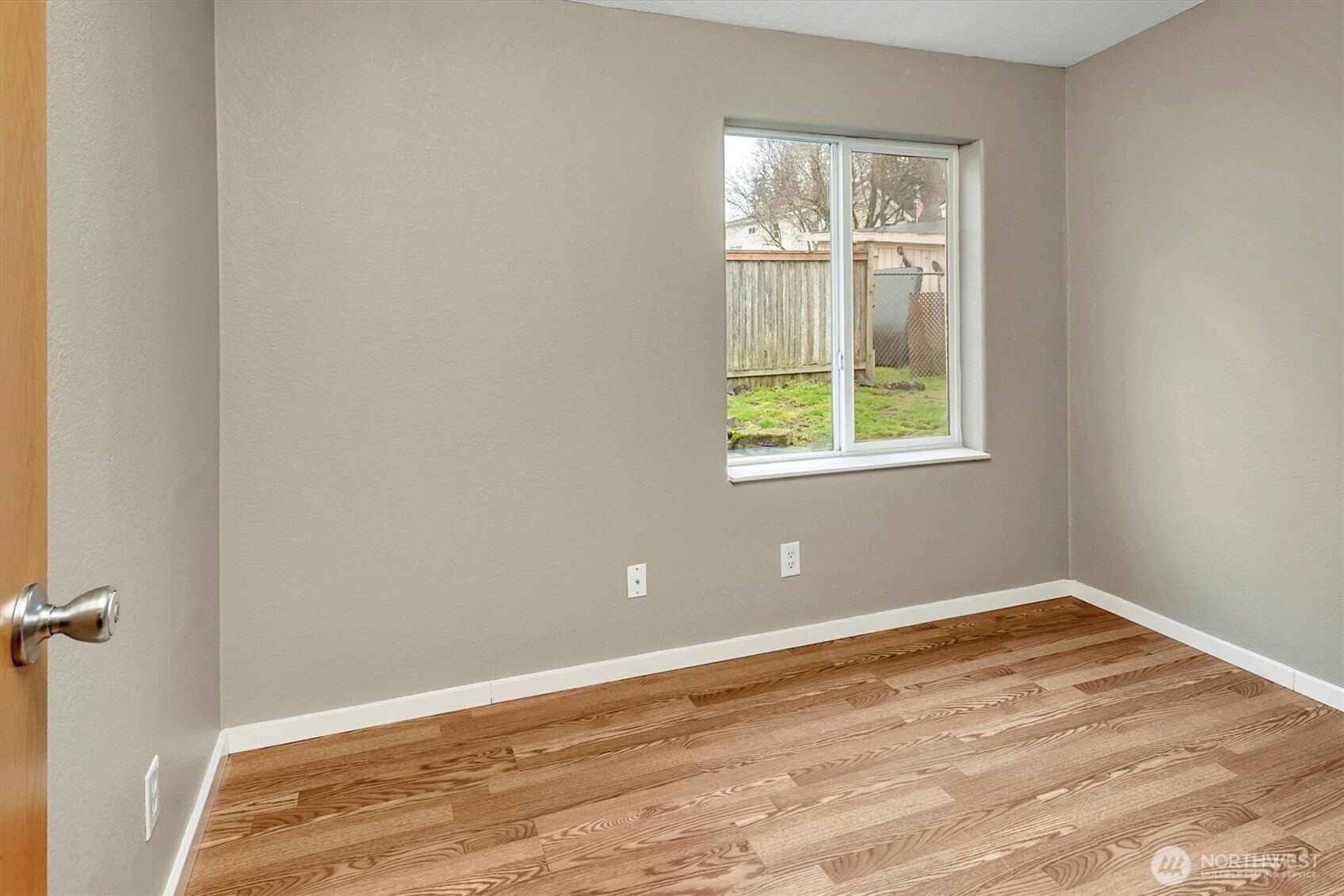 6407 Cady Road, Unit C Everett, WA 98203 - Photo 17 of 27 a view of an empty room with wooden floor and a window