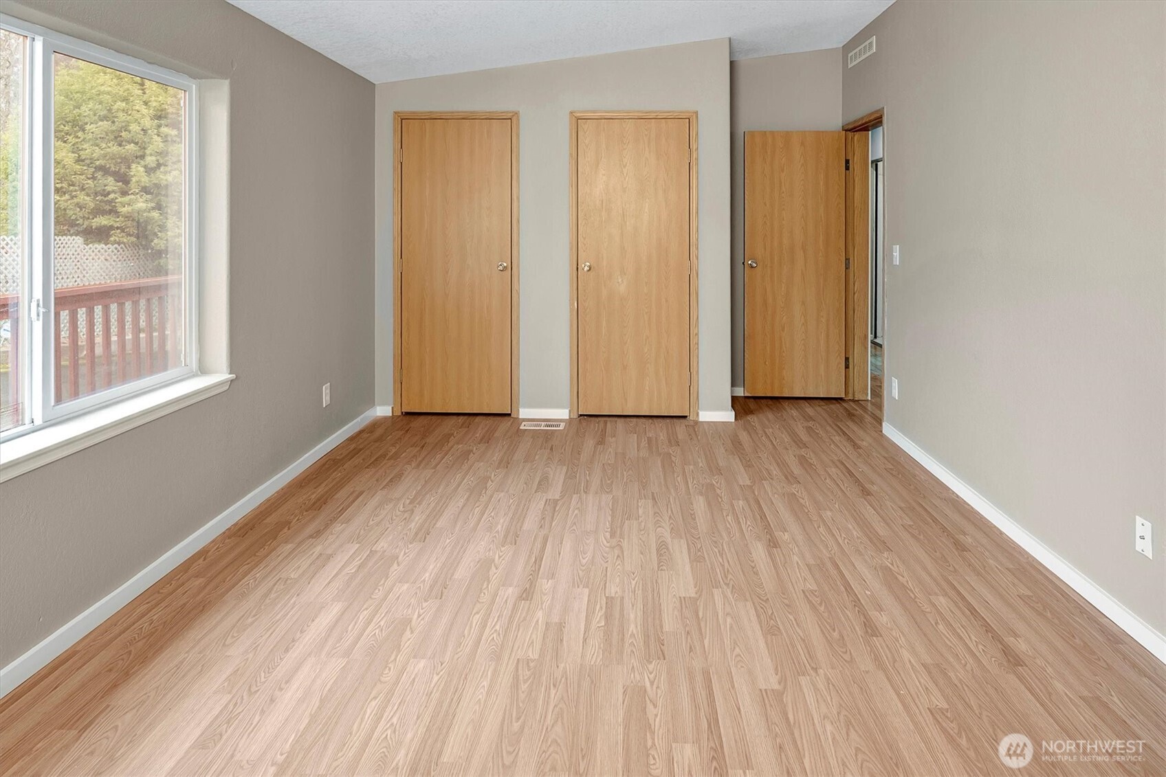 6407 Cady Road, Unit C Everett, WA 98203 - Photo 19 of 27 an empty room with wooden floor and windows