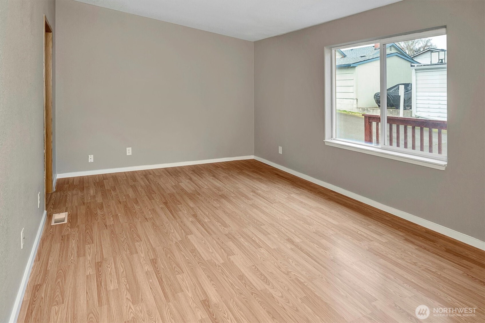 6407 Cady Road, Unit C Everett, WA 98203 - Photo 20 of 27 a view of an empty room with wooden floor and a window