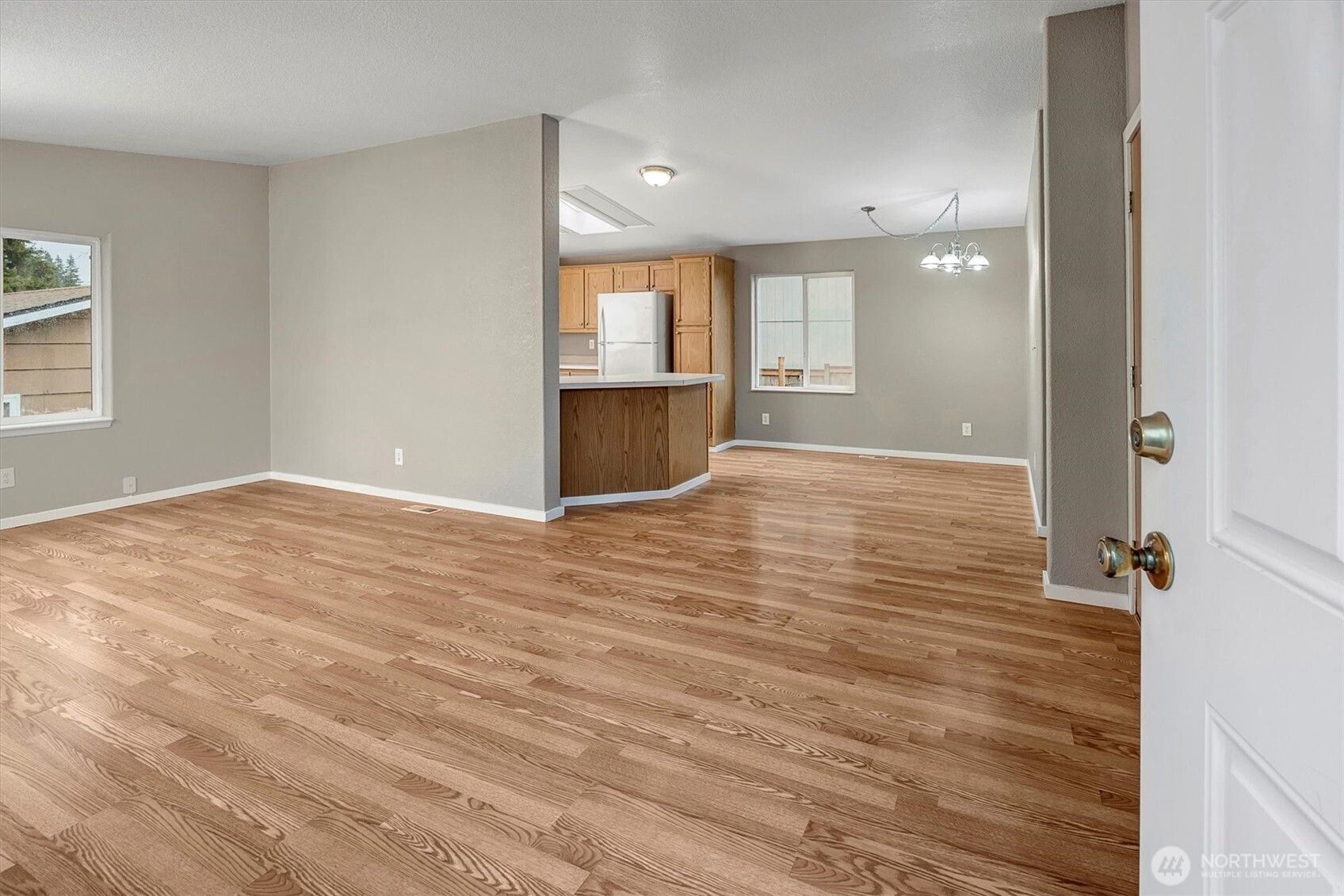 6407 Cady Road, Unit C Everett, WA 98203 - Photo 4 of 27 a view of an empty room with wooden floor and a window